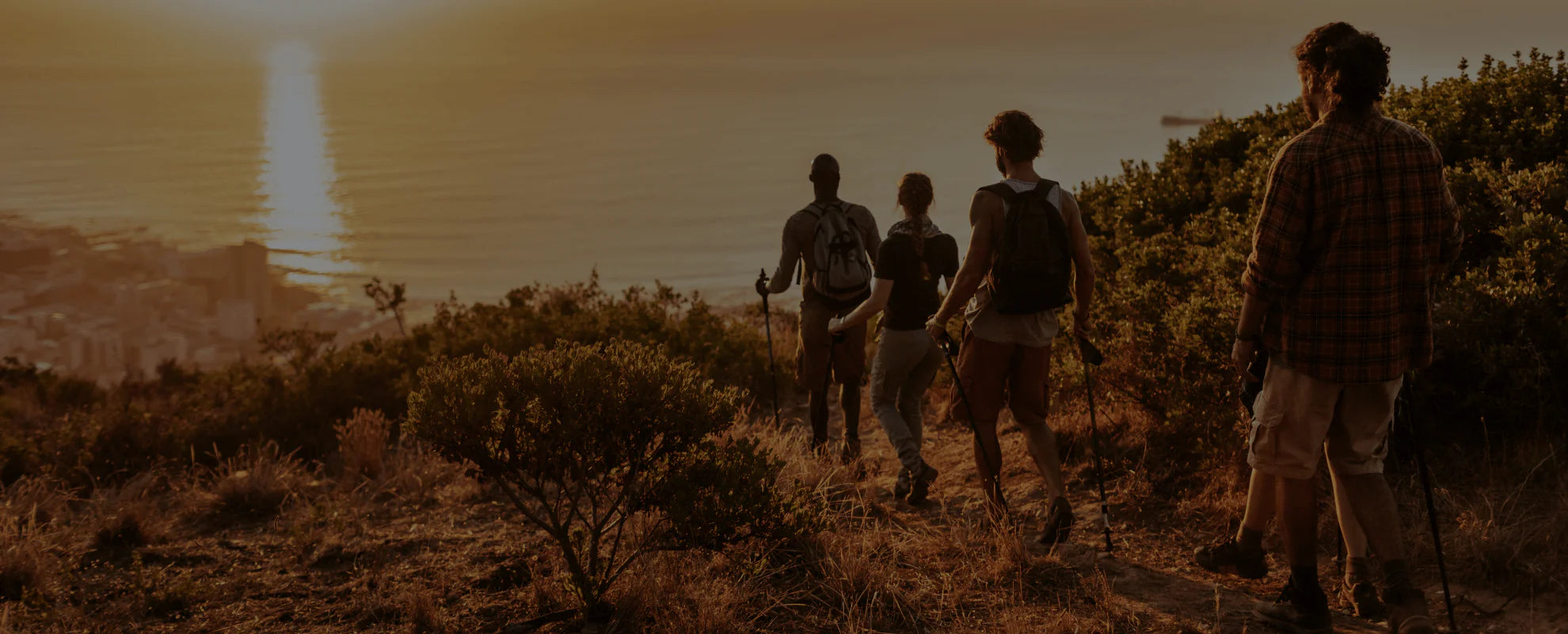 People hiking at sunset